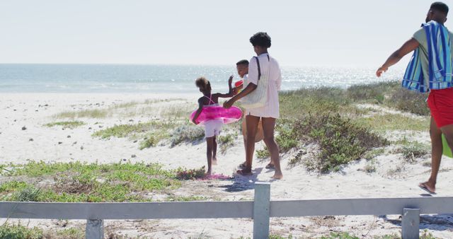 Family Heading to Beach with Inflatable Ring - Download Free Stock Images Pikwizard.com