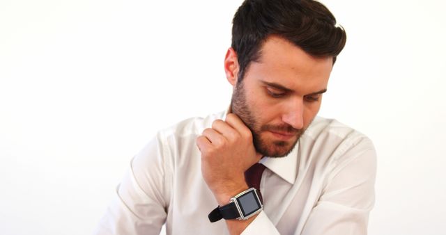 Businessman With Smartwatch, Looking Down Thoughtfully - Download Free Stock Images Pikwizard.com