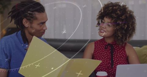 Collaborative Colleagues Reviewing Files in Modern Lounge