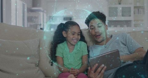 Father and daughter exploring tablet together with holographic globe augmented reality learning