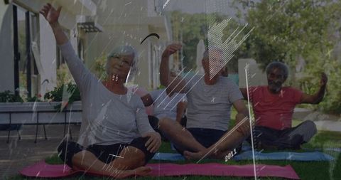 Senior group practicing gentle outdoor yoga and stretching on mats in sunny courtyard