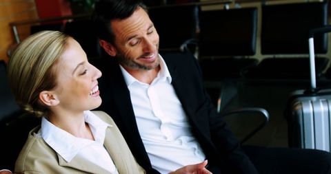 Business Professionals Engaging at Airport Waiting Area