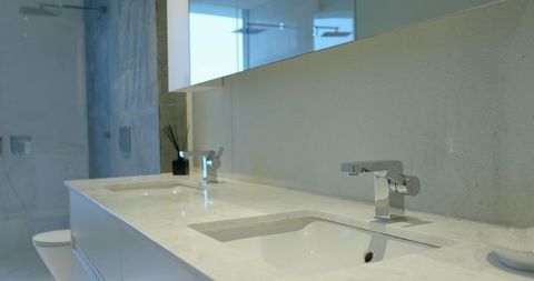 Modern minimalist double sink bathroom with chrome faucets
