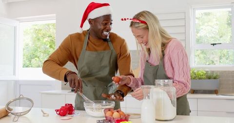 Diverse Couple Baking Together in Festive Kitchen