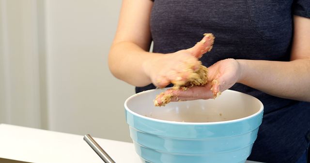 Woman Mixing Ingredients by Hand in Blue Bowl in Kitchen - Download Free Stock Images Pikwizard.com