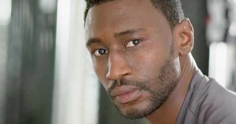 African american man closeup headshot holding gaze intense expression diffused lighting