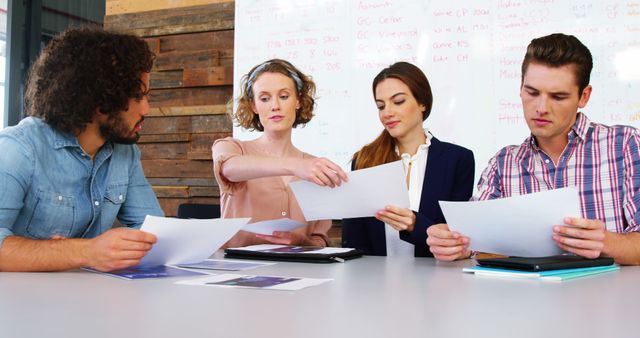 Young Professionals Reviewing Documents in Office Meeting - Download Free Stock Images Pikwizard.com