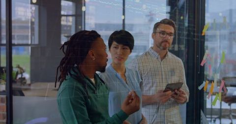 Cross-Functional Team Collaborating on Strategy with Glass Board, Sticky Notes and Tablet