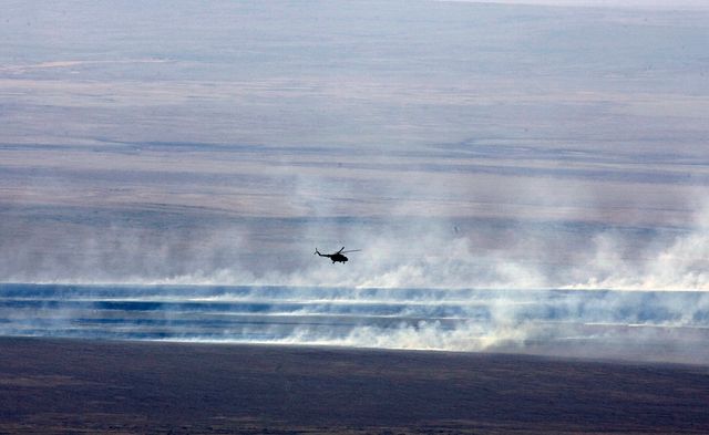 A Russian search and rescue helicopter flies over the burning Kazakh steppe after Expedition 16 Commander Peggy Whitson, Flight Engineer and Soyuz Commander Yuri Malenchenko and South Korean spaceflight participant So-yeon Yi landed their Soyuz TMA-11 spacecraft, Friday, April 19, 2008, in central Kazakhstan to complete 192 days in space for Whitson and Malenchenko and 11 days in orbit for Yi.  Photo Credit: (NASA/Reuters/Pool)