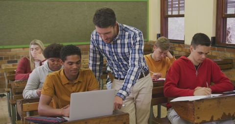 Teacher Assisting Students in Classroom with Technology - Download Free Stock Images Pikwizard.com