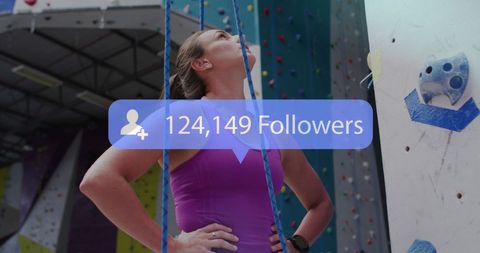 Woman climber at indoor gym with social media follower icon