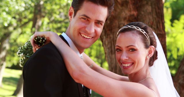 Happy Bride and Groom Posing in Park on Their Wedding Day - Download Free Stock Images Pikwizard.com