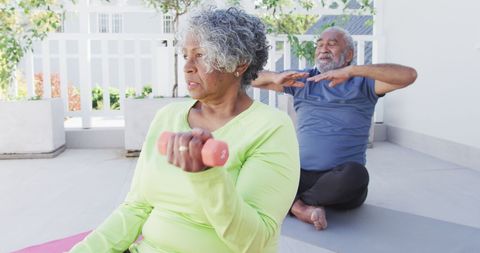 Senior African American Couple Staying Active with Yoga and Weights