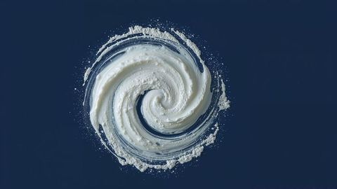 Swirling creamy spiral design on dark blue background