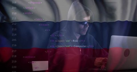 Hacker wearing hoodie typing on laptop with html code overlay and tricolor flag backdrop