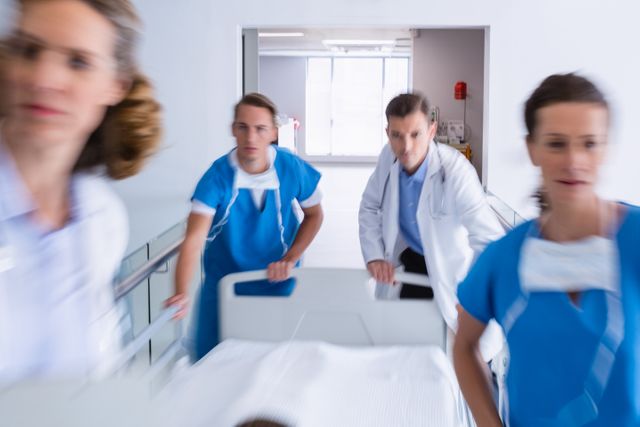 Medical Team Rushing with Emergency Stretcher in Hospital Corridor - Download Free Stock Photos Pikwizard.com