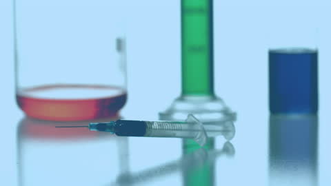 Laboratory Syringe with Rotating Elements and Colored Liquids