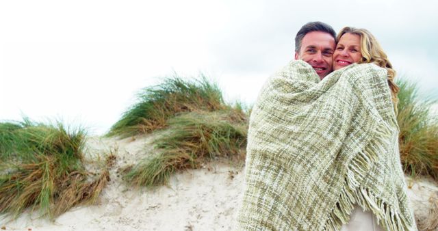 Senior Couple Embracing Under Blanket on Beach - Download Free Stock Images Pikwizard.com