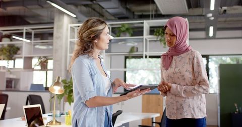 Diverse Female Colleagues Collaborating in Open-Plan Office