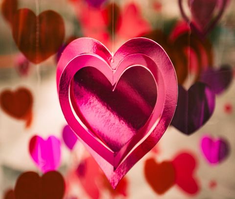 Vibrant pink heart cutouts hanging as festive decorations