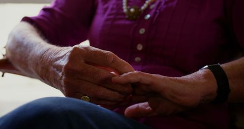 Senior Woman Folding Hands on Lap Relaxed at Home