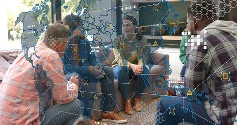 Cross-functional team collaborating over augmented global data map in casual office lounge