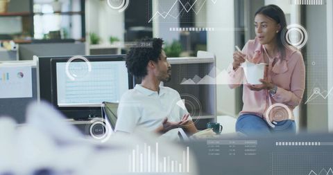 Colleagues Engaging in Data Analysis Discussion at Modern Office