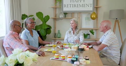Senior Friends Celebrating Retirement with Laughter and Treats