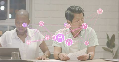 Team collaborating over documents and tablet with pink digital network overlay