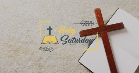 Resting wooden cross on open journal with holy saturday lettering, minimalist flatlay