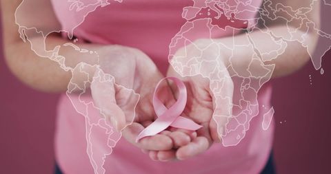 Pink ribbon and world map symbolizing global breast cancer awareness