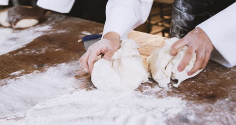 Bakers Kneading Dough in Rustic Bakery Kitchen