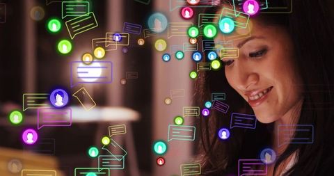 Chinese woman checking messages and smiling in warm lounge with color chat overlays