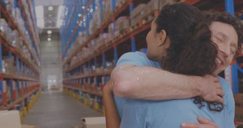Diverse warehouse workers embracing teamwork and unity