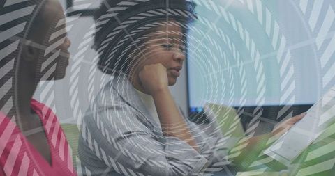 Coworkers reading document together in modern office, collaborating on project planning