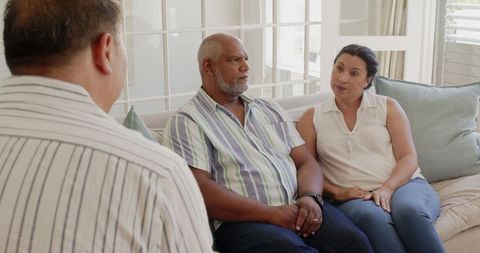 Senior Diverse Couple Listening to Advisor at Home