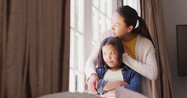 Mother Hugging Daughter While Looking Out Window - Download Free Stock Images Pikwizard.com