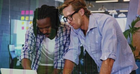 Focused Colleagues Collaborating on Data Visualization in Modern Office