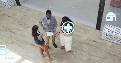 Diverse Team Discussing Eco Icons and Data Innovation in Modern Office