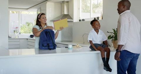 Family Morning Preparation in Modern Kitchen with School Supplies
