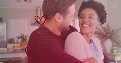 Playful Mixed Race Couple Embracing in Cozy Kitchen