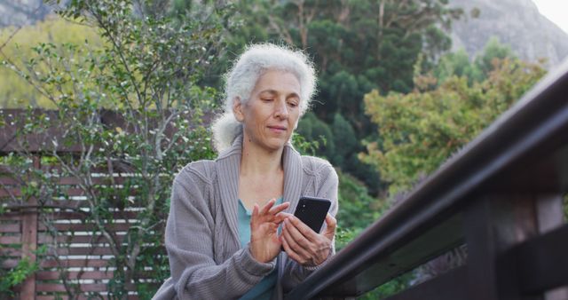 Senior Woman Using Smartphone Outdoors In Garden Setting - Download Free Stock Images Pikwizard.com