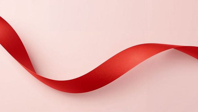 Flowing Crimson Ribbon Curving Across Soft Pink Background for Gift Holiday Celebration