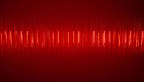 Crimson neon tube installation with suspended vertical bars and reflective floor