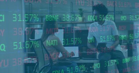 Colleagues Analyzing Financial Data on Tech Devices in Modern Office Environment