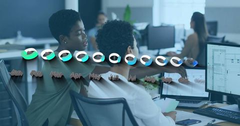 Coworkers Analyzing Financial Data in Collaborative Office Space