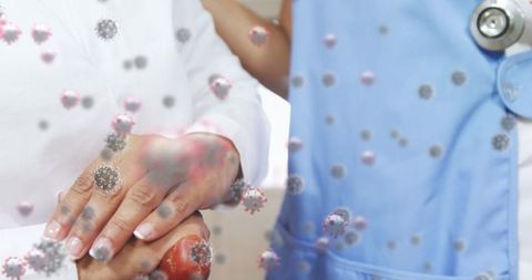 Healthcare worker comforting patient amidst floating virus particles