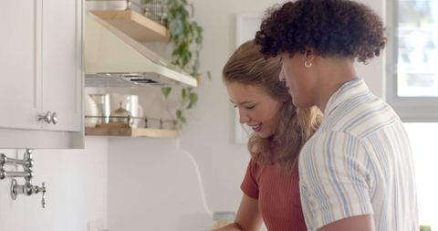 Joyful Couple Cooking Together in Modern Kitchen Environment