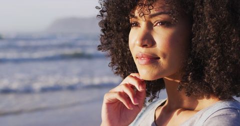 Reflective Young Woman Enjoying Beach Sunset