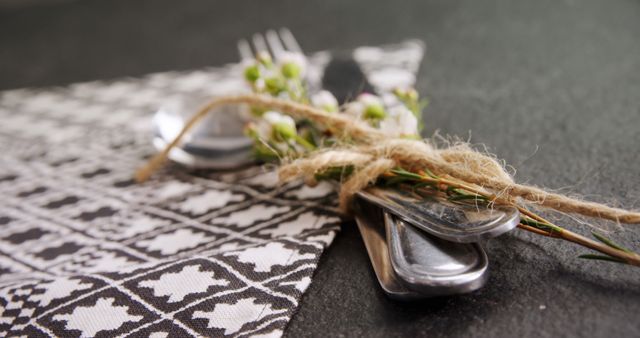 Rustic elegant table arrangement for a dining event or special occasion. Ideal for restaurant menus, wedding invitations, and event planning brochures emphasizing sophisticated and handcrafted décor.